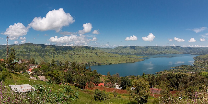 Majestic view of Dhom Lake in Panchgani, surrounded by hills and lush greenery