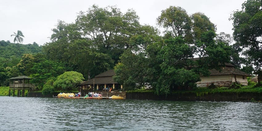 Beautiful view of Dhamapur Lake surrounded by lush greenery and calm waters.