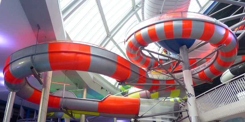 A large water slide leading to a pool, much like those at Kathmandu's water parks.