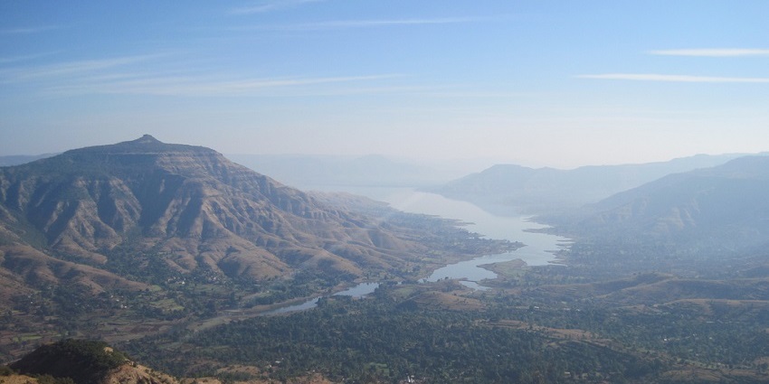 Dhom Lake reflects serene beauty and scenery, surrounded by the lush Western Ghats