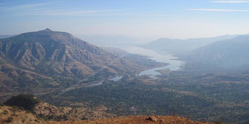 An image of Dhom Dam, the scenic reservoir, serene views, and recreational activities.