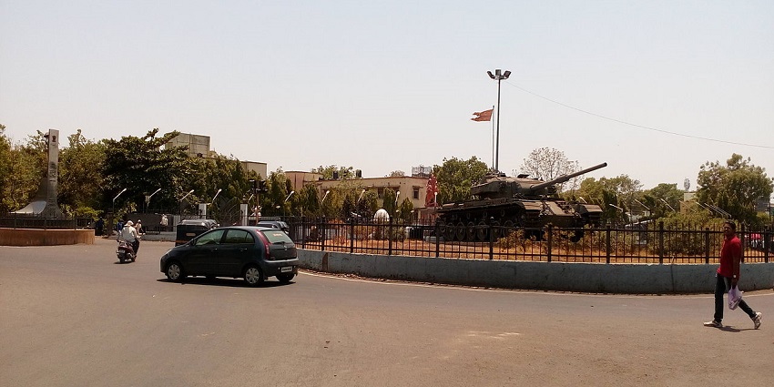 A roundabout with a large statue and decorative plants, one of the famous places near Laling Fort.