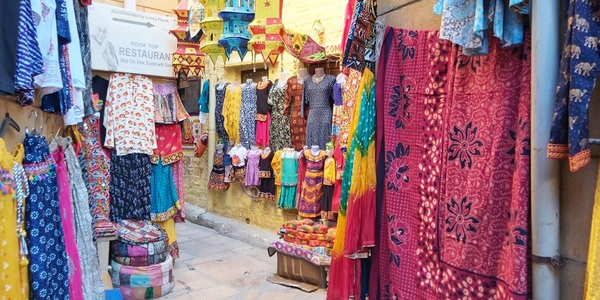 Vibrant clothing hanging out of the shops at Dindori Road Market