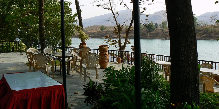 The view of the lake next to a picturesque restaurant in Aamby Valley