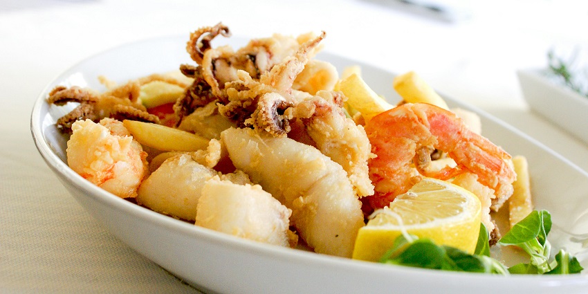 Seafood platter with fish, shrimp, crab, clams, and squid in a restaurant in Jimbaran