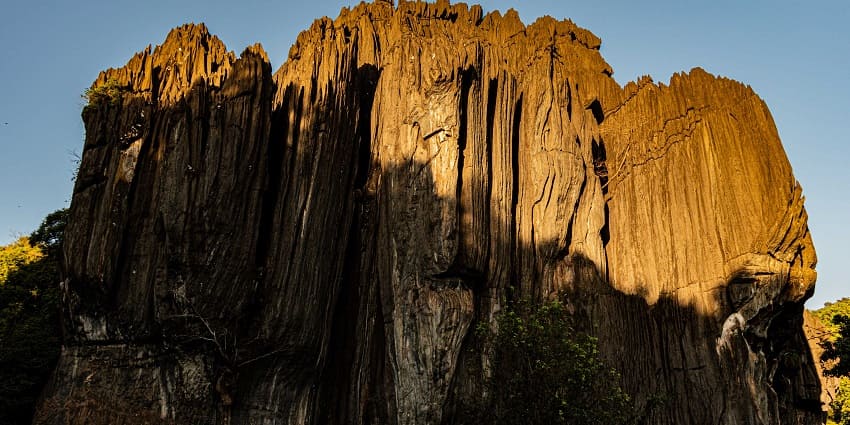 The towering rock formations at Yana Caves, surrounded by dense forests