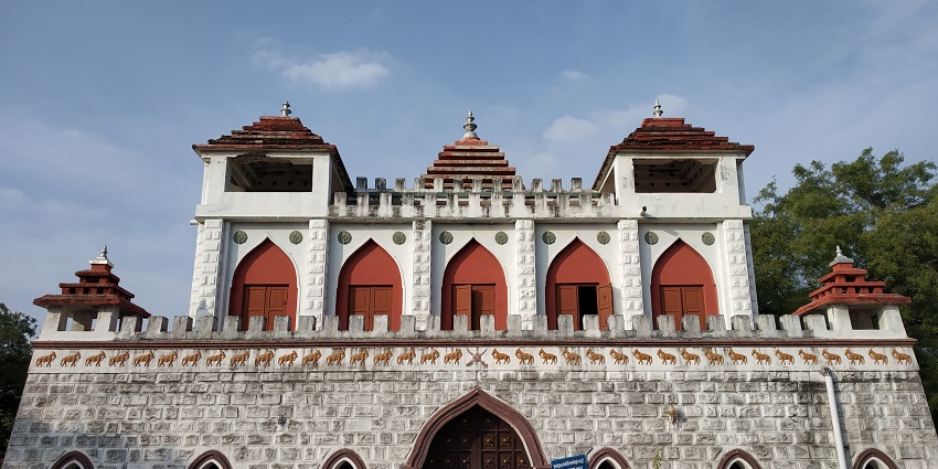 A photo of Panchalankurichi Fort, a historical fort with ancient stone walls and lush greenery