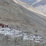 A picture of a monastery perched atop a barren hill