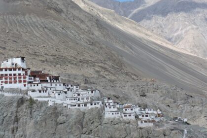 A picture of a monastery perched atop a barren hill