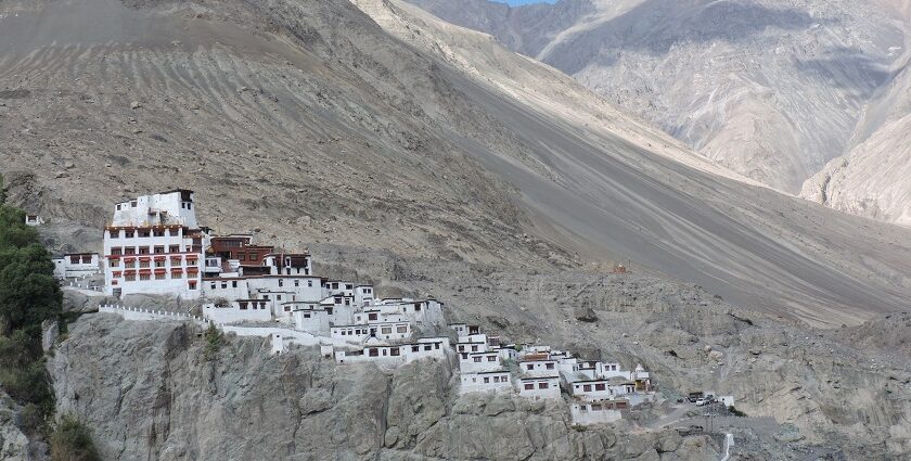 A picture of a monastery perched atop a barren hill