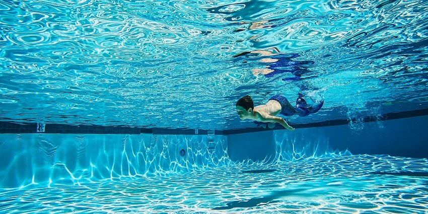 An image of a person diving in the Shell City Water Park Indore wave pool.