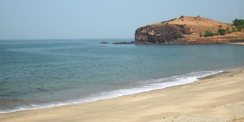 Serene view of Diveagar Beach with its golden shoreline and gentle waves
