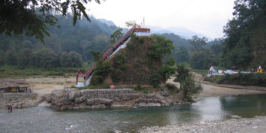 View of a temple in the village surrounded by lush greenery