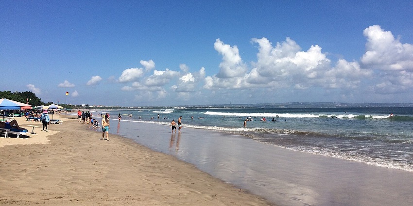 Picturesque view of the crystal clear water waves crashing the golden shores of double six beach