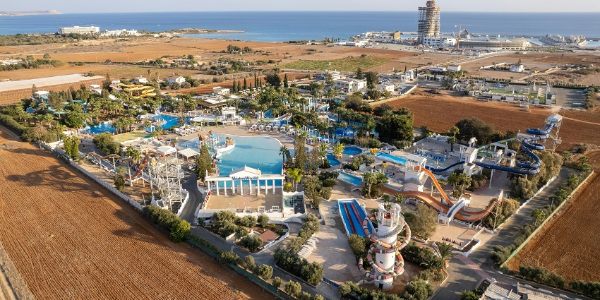 Aerial View of the water park with twisty rides, during day time and clear blue sky