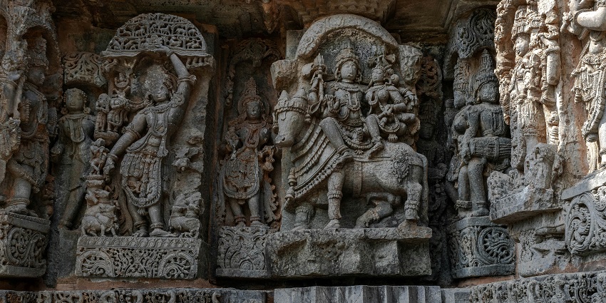 The Intricate stone carvings adorn this ancient Hindu temple, showcasing rich details
