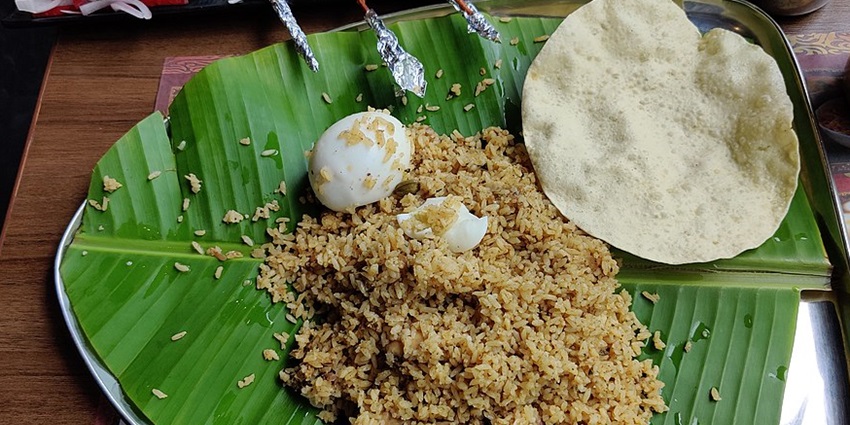 Flavorful egg biryani available at bustling Moonjikal Market.