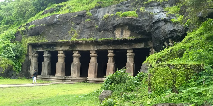 A picture of the giant entrance of a cave located amidst the verdant valleys of Maharashtra