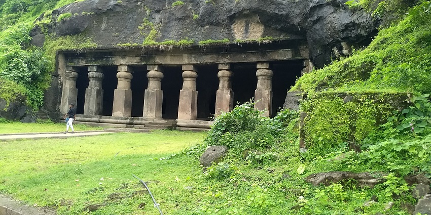 A picture of the entrance of Elephanta Caves, a UNESCO World Heritage Site, with greenery spread all around
