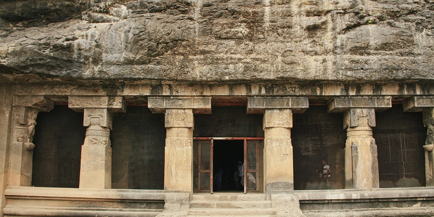 A front view of the iconic Ellora Caves, a famous tourist attraction in Maharashtra.