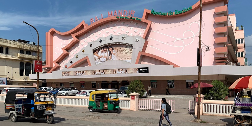 A picture of the Raj Mandir Cinema taken from across the road, painted in orange walls