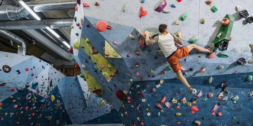 Image of a man in active wear climbing in an indoor climbing wall - Equilibrium Climbing Station
