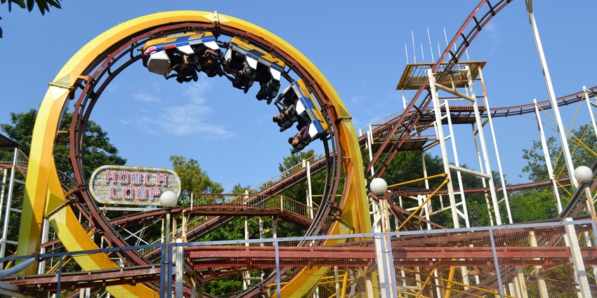 A vibrant scene at Essel World, showcasing thrilling rides and joyful visitors enjoying their day out