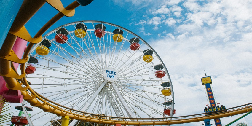 Enjoy thrilling views from a Ferris wheel next to an exhilarating roller coaster ride.