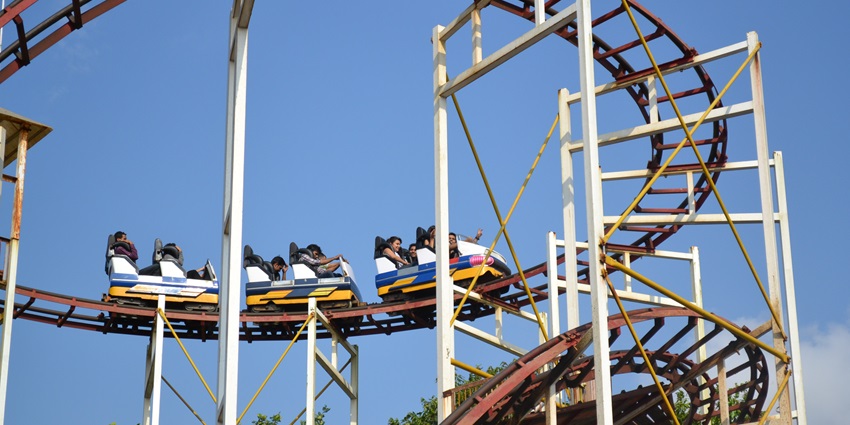 A wide-angle view of EsselWorld Amusement Park in Mumbai, featuring various rides and a colourful settings