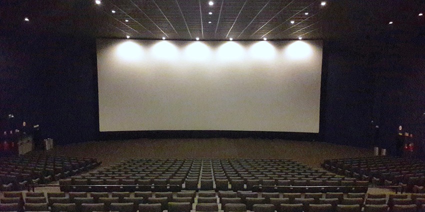 An image of the empty movie theatre and the big screen where movies will be displayed.
