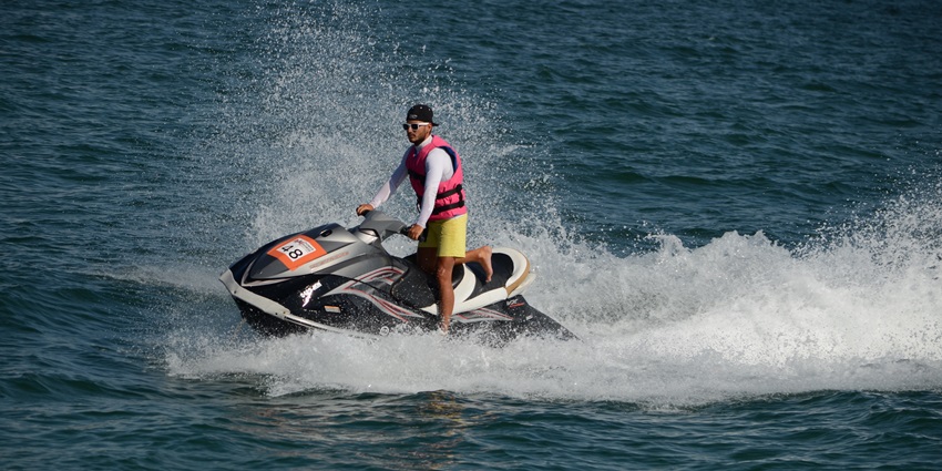 A picture of a person riding the water jet ski in the scenic blue waters of the Arabian sea