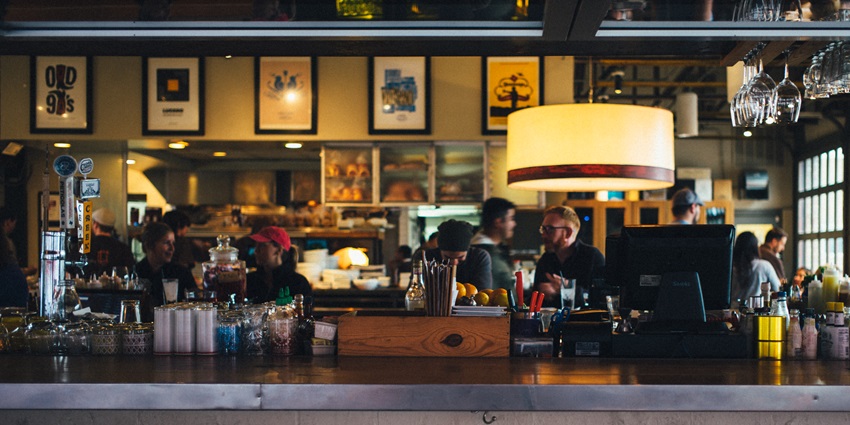 A picture of a bar counter at a pub in Chembur with a cosy ambience amidst yellow hues in the background