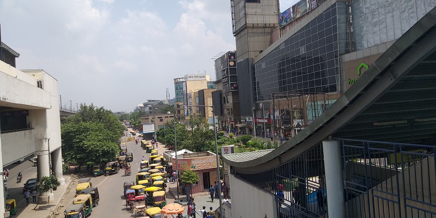 MG Road metro station with a large crowd.