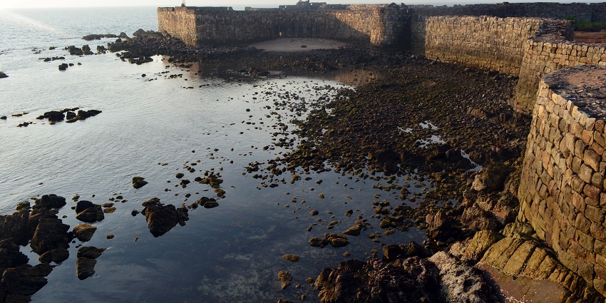 View of the back wall of Sindhudurg Fort, showcasing the strong stone structure.