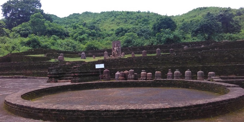 Various brown-coloured stupas and sculptures are placed on the other side of the circle