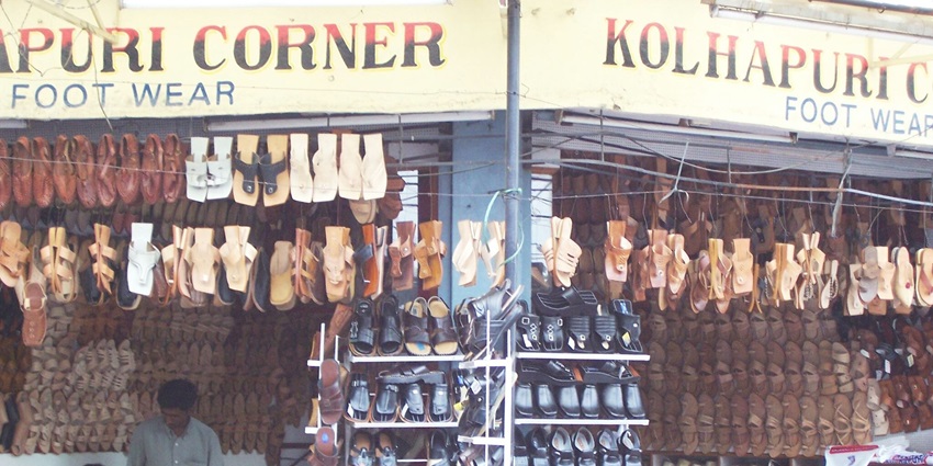 Vibrant Shivaji Market filled with stalls selling Kolhapuri Fruits, spices, and textiles.