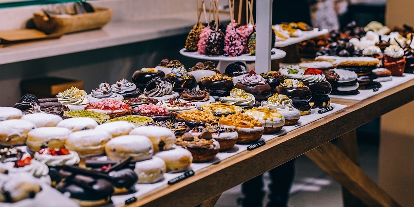 A variety of freshly baked breads displayed in a bakery, showcasing different textures.