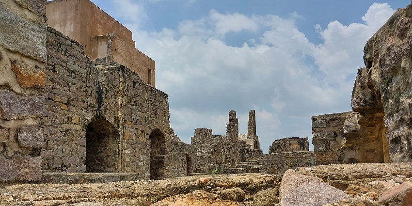 Ruins of Rani Mahal in Golconda Fort with intricate carvings and arched openings