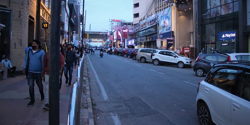 Vibrant view of MG Road bustling with shops, pedestrians, and lively street activities