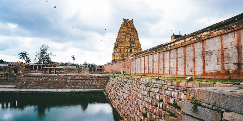 A view of the renowned Uppiliappan Temple surrounded by lush greenery and waters.