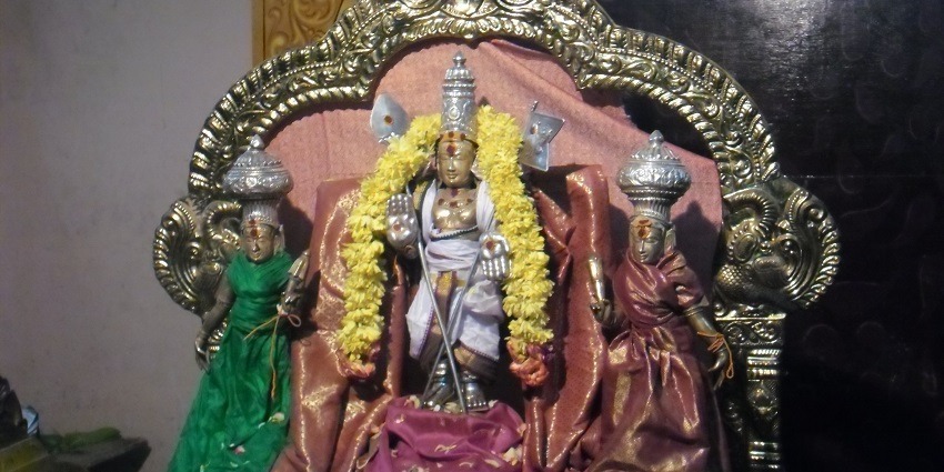 A picture of a temple showing three deities, featuring Murugan, Valli and Deyvaanai.
