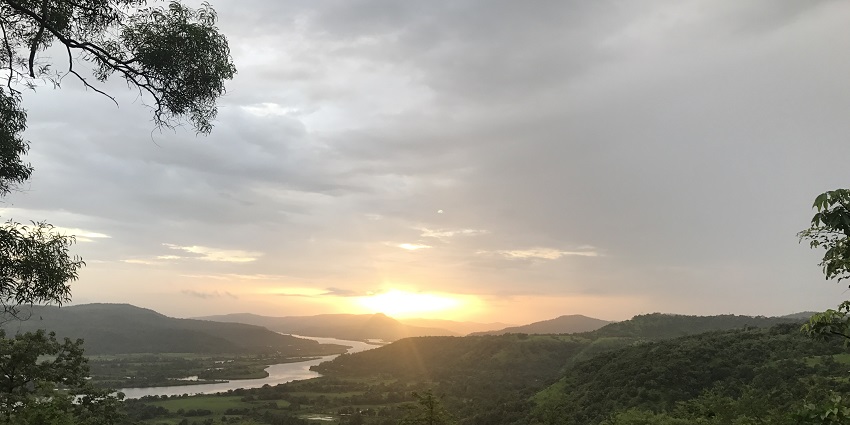 Serene Vashishti River flowing through lush greenery, a must-see among things to do in Chiplun.