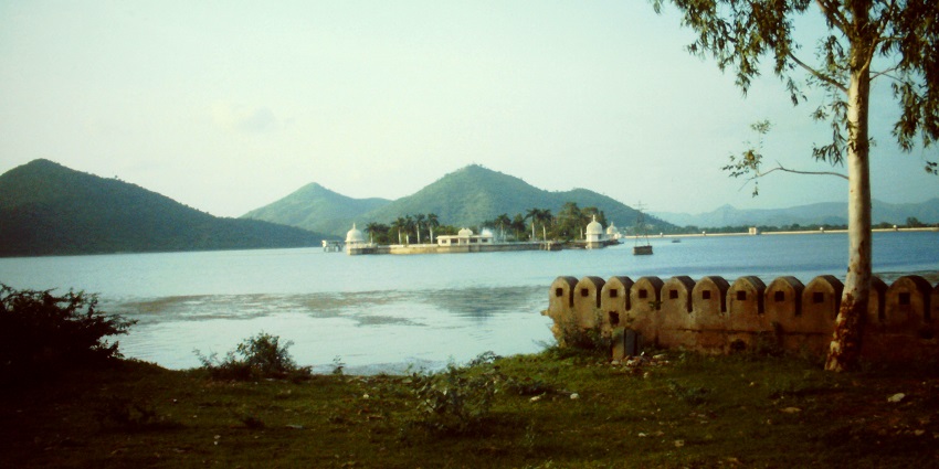 Calm waters of Fateh Sagar Lake with a distant island and Aravalli hills in view
