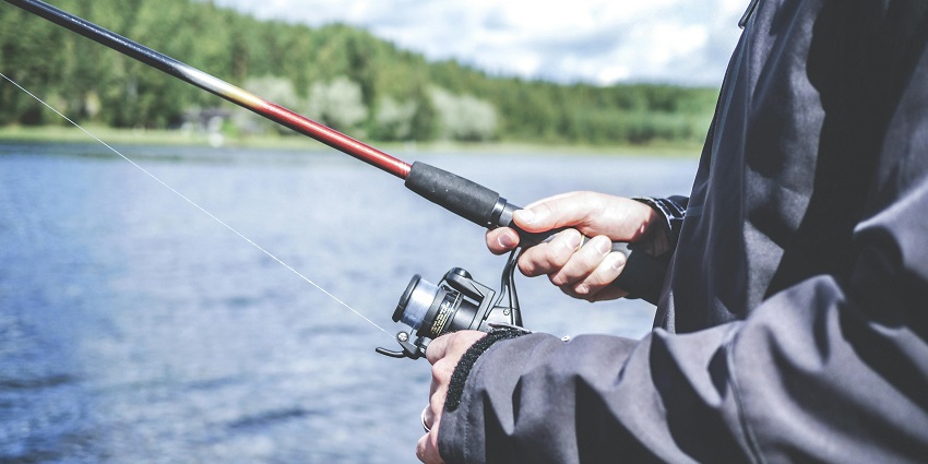An image of an angler casting a line at Tungarli Lake, one of the top water sports near Pune.