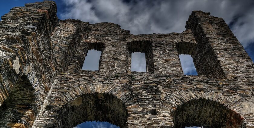 Ancient castle ruins, a historic tourist attraction in Maharashtra amid rugged terrain.