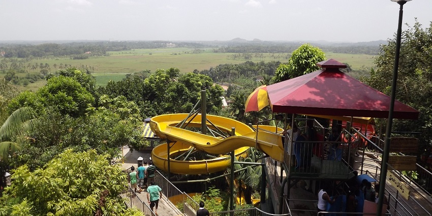 Image of amusement park near lush green field during the day time - water park in Vizag