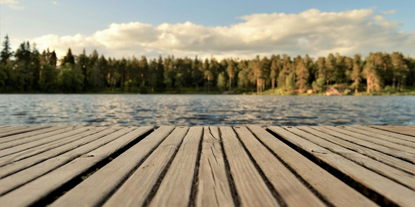 A serene view of Futala Lake, surrounded by lush greenery and reflecting the clear blue sky.