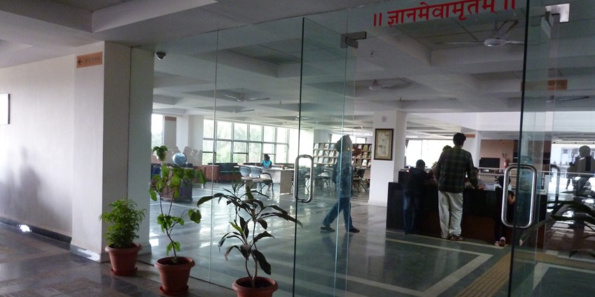A serene library filled with Gandhian literature and research materials.