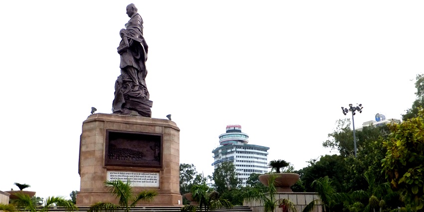 Statue of Mahatma Gandhi standing in Gandhi Maidan surrounded by land and buildings
Statue of Mahatma Gandhi standing in Gandhi Maidan surrounded by land and buildings