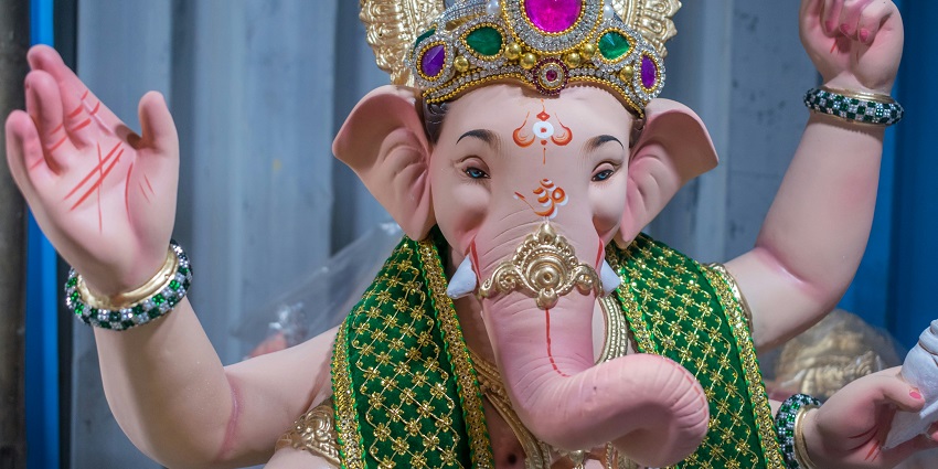 A view of a majestic idol of God in vibrant shades and quaint designs in Maharashtra.
